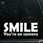 Smile You’re On Camera – 9″ x 3-1/4″ – Vinyl Die Cut Decal/Bumper Sticker for Windows, Cars, Trucks, Laptops, Etc.